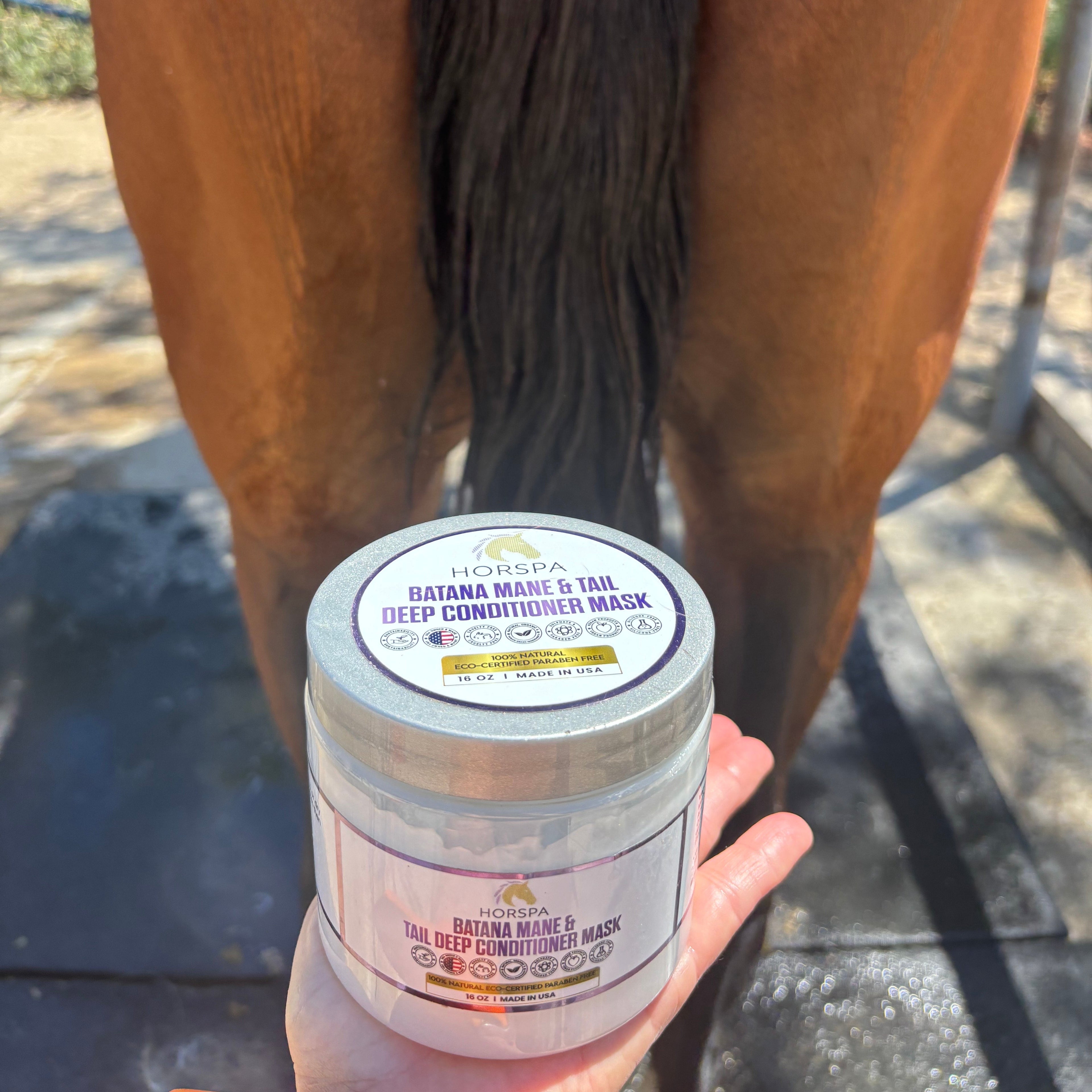 Person holding a jar of horse care product next to a horse's mane and tail.